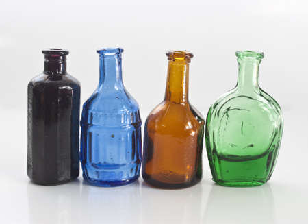 some different coloured old style medicine bottlesの写真素材