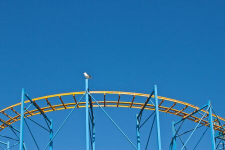 fairground roller caoster ride with blue skyの写真素材