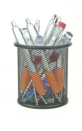 junk and pens in a desk tidy potの写真素材