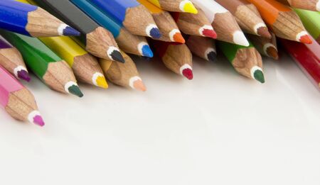 some coloured pencil tips top of a pageの写真素材
