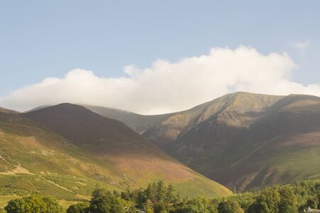 Mountain peaks and blue sky in Eskdale valley, Lake District, UK.の写真素材