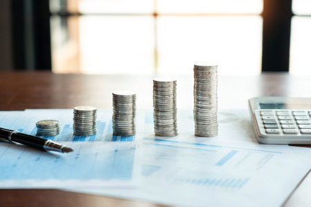 Pile stack of coins saving money and planning financial, accounting  or investment concept.
