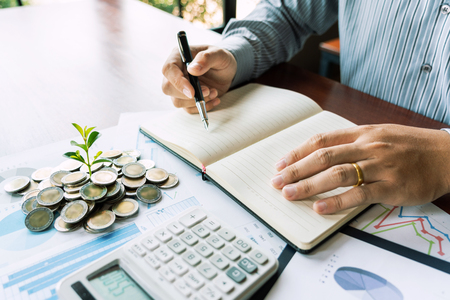 strategy analysis concept, Businessman working  financial Manager Researching Process accounting calculate analyse market graph data stock information review on the table in officeの写真素材