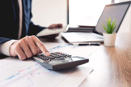 strategy analysis concept, Businessman working  financial Manager Researching Process accounting calculate analyse market graph data stock information review on the table in officeの写真素材