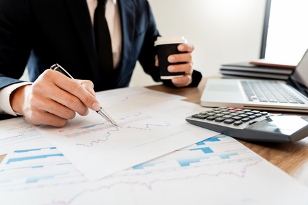 strategy analysis concept, Businessman working  financial Manager Researching Process accounting calculate analyse market graph data stock information review on the table in officeの写真素材