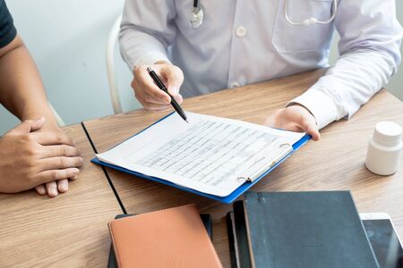 Doctor explaining and giving a consultation to a patient medical informations and diagnosis about...