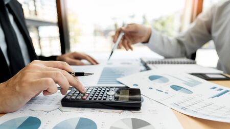 Business Corporate team brainstorming, Planning Strategy having a discussion Analysis investment researching with chart at office his desk documents and saving concept.の写真素材