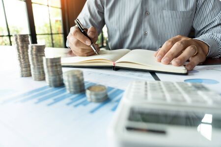 strategy analysis concept, Businessman working  financial Manager Researching Process accounting calculate analyse market graph data stock information review on the table in officeの写真素材