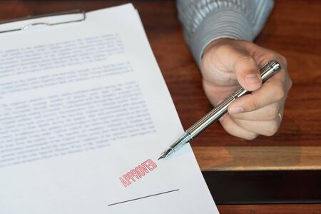male point to signing business document for putting signature, fountain pen and approved stamped on...