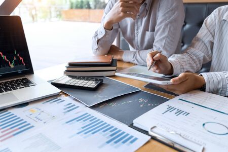 Working business man, team of broker or traders talking about forex on multiple computer screens of stock market invest trading financial graph charts data analysisの写真素材