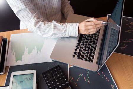 Working business man of broker or traders thinking about forex on multiple computer screens of stock...