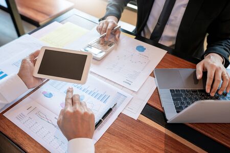 Business Corporate team brainstorming, Planning Strategy having a discussion Analysis investment researching with chart at office his desk documents and saving concept.の写真素材
