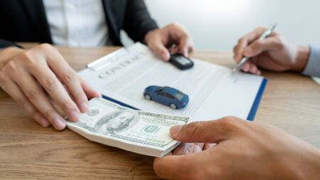 agent broker man holding document showing an transportation contract form to client ownership  customer and salesman with car keyの写真素材