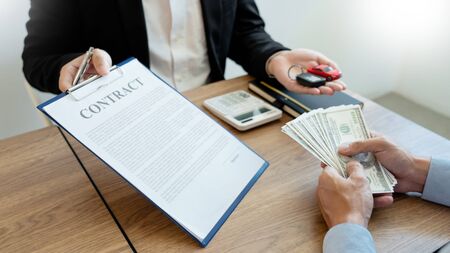 agent broker man holding document showing an transportation contract form to client ownership  customer and salesman with car keyの写真素材