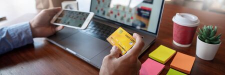 Online shopping credit card data security concept, Hands holding credit card and using smart phone...