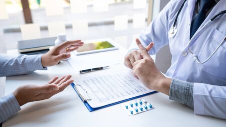 Doctor explaining and giving a consultation to a patient medical informations and diagnosis about...