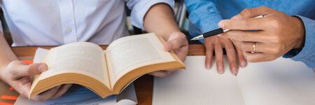 tutor and college students teaching school work and explaining problem solution studying and reading...