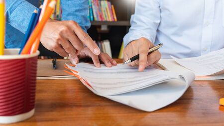 College tutor helps friend teaching and learning for a test or an exam catching up, education and...