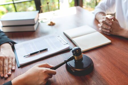 Male Notary lawyer or judge consult or discussing contract papers with Businessman client in office, Law and Legal services concept.の写真素材