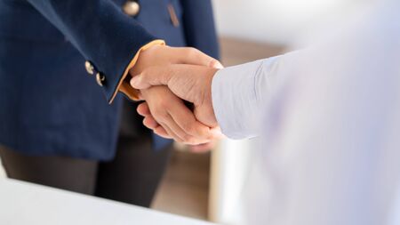 Good deal. Close-up of beautiful women business people shaking hands whileÂ successfulÂ job...
