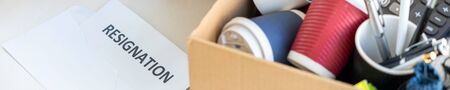 Businesswoman resigning from her job hold boxes and packing personal company for personal belongings. deciding resignation concept and changing work in futureの写真素材