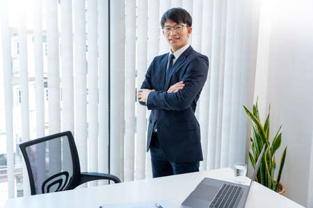 Stressed Young asian business man working late night alone in office late his eyes are gonna closing...