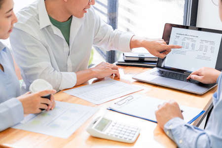 Asian businessman insurance broker or financial advisor consulting young millennial couple clients...