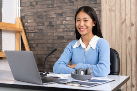 Educational concept young smart female teacher looking at webcam and teaching online lesson by video conference call on a computer during the coronavirus outbreak.の写真素材