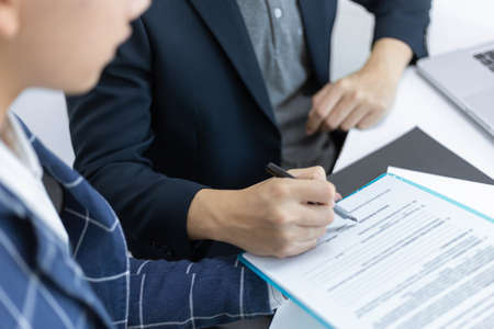 Business partners concept two young male producers discussing and changing ideas for developing a...