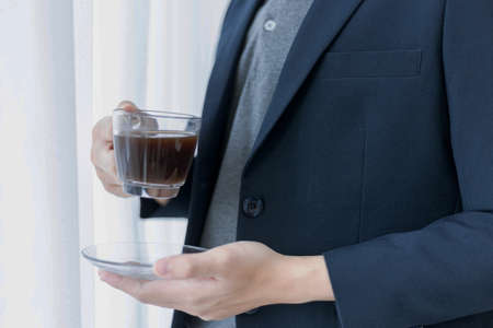 Business partners concept a young male entrepreneur enjoying with tasty coffee while creating concept of a new project.の写真素材