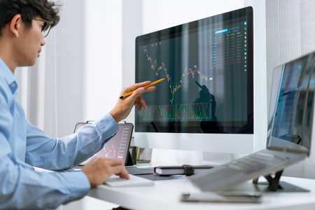 Financial concept a businessman studying the stock chart analyzing the growths of the stock from the...
