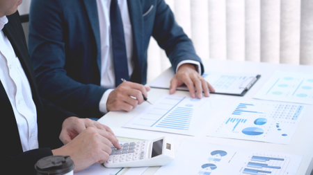 Business concept a couple of business partners calculating annual income and expense for creating the next financial planの写真素材