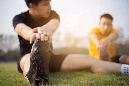 Sports and recreation concept a young male adult preparing himself before workout that helping reduce muscle soreness and lessen your risk of injury.の写真素材