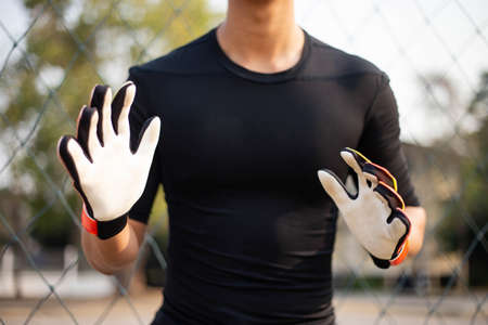 Sports and recreation concept a male amateur player practicing as a goalkeeper position rehearsing to catch the ball.の写真素材