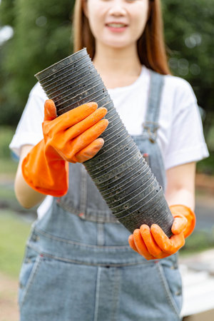 Female gardener concept amount of plastic pots stacking together, in the hands of the female...