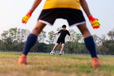 Sports and recreation concept a male amateur player practicing as a goalkeeper position rehearsing to catch the ball from free-kicks.の写真素材
