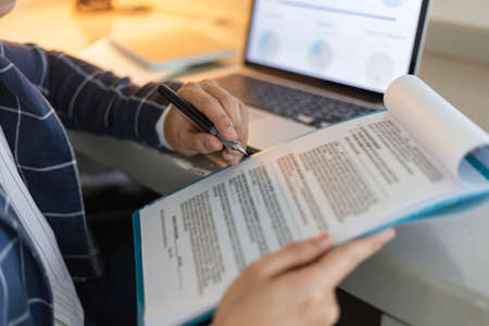 Business partners concept a young male entrepreneur signing a signature on the contract with a big...