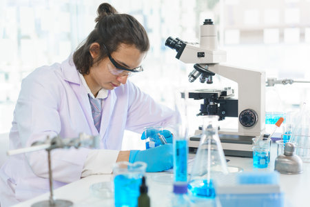 Laboratory research concept, Scientist working in lab and writing result of experiment on document.の写真素材