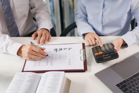 Business concept, Two business colleague brainstorm about investment and calculate cost of project.