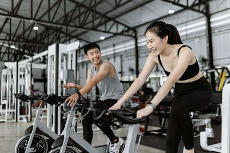 exercise concept The well-shaped lady and the muscular man being entertaining having small chat...