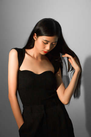 Fashion and beauty concept, Fashion woman with glowing makeup and pose on gray background.の写真素材