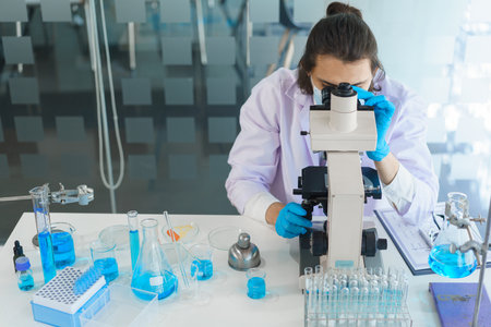 Laboratory research concept, Scientist using microscope to research and development of vaccine.