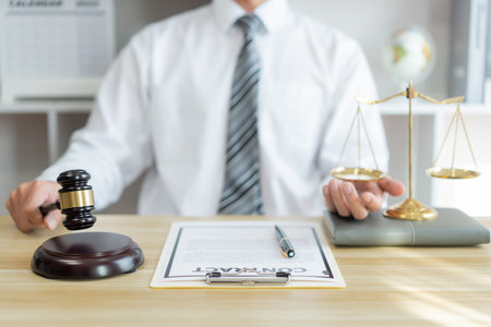 Law consultancy concept A male lawyer hitting a gravel to give a right to act this contract officially after reading it entirelyの写真素材