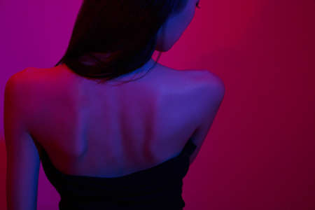 Fashion and beauty concept, Fashion woman in black dress to pose in neon light background.の写真素材