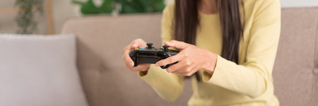 Relaxation concept, Young woman sitting on the couch to playing video games with joystick console.の写真素材