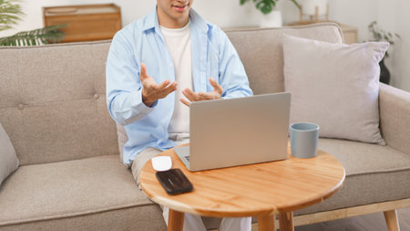 Business at home concept, Businessman wears wireless headphones meeting on video call in laptop.