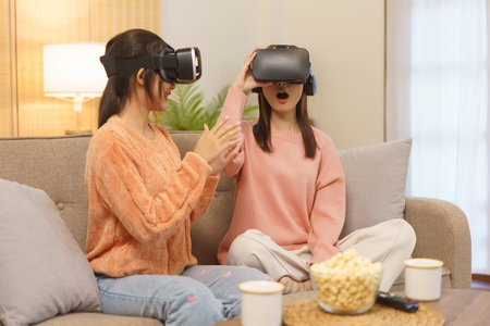 Friendship concept, LGBT lesbian couple wears VR goggles in virtual reality experience with excited.の写真素材