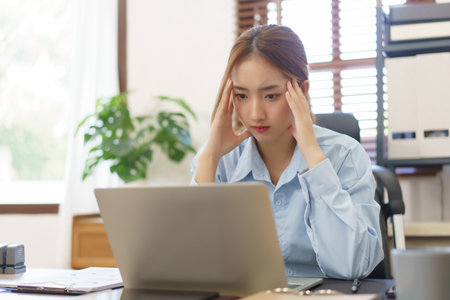 Business concept, Businesswomen stressful while reading financial report on laptop at workplace.