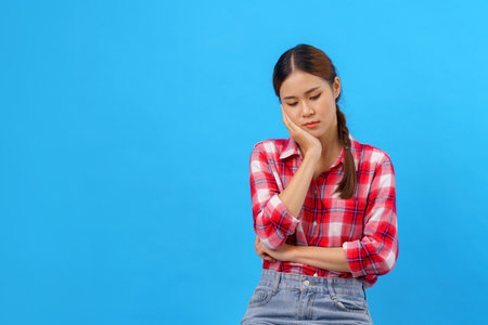 Women are feeling sadness and disappointed with empty space on isolated light blue background.の写真素材