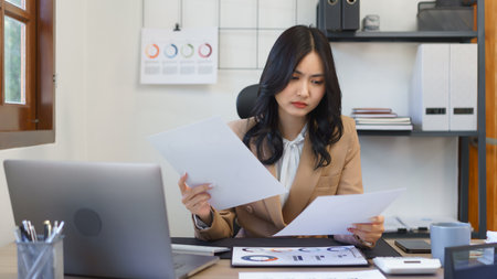 Secretary concept, Female secretary stressful while working and reading business document in office.の素材